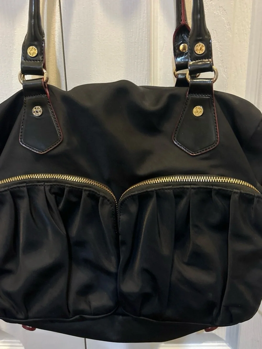 MZ Wallace Black Shoulder Bag with Gold and red Accents and pink interior